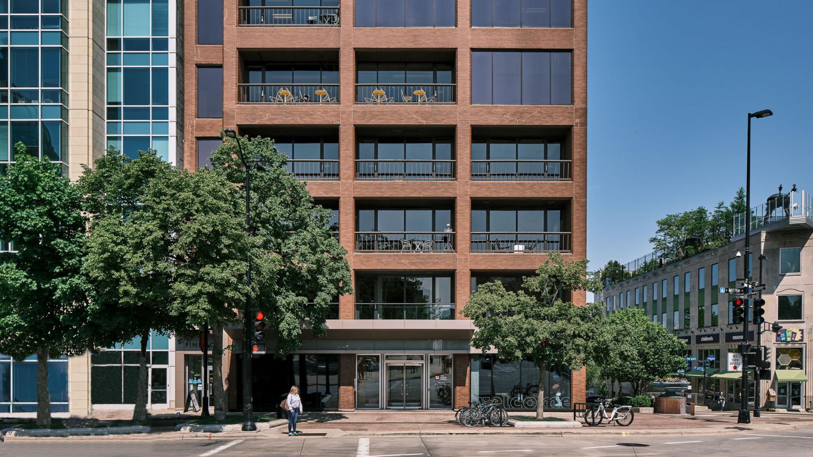 Modern glass and steel office building at 44 East Mifflin Street, featuring a sleek façade with floor-to-ceiling windows and a prominent Capitol Square location.