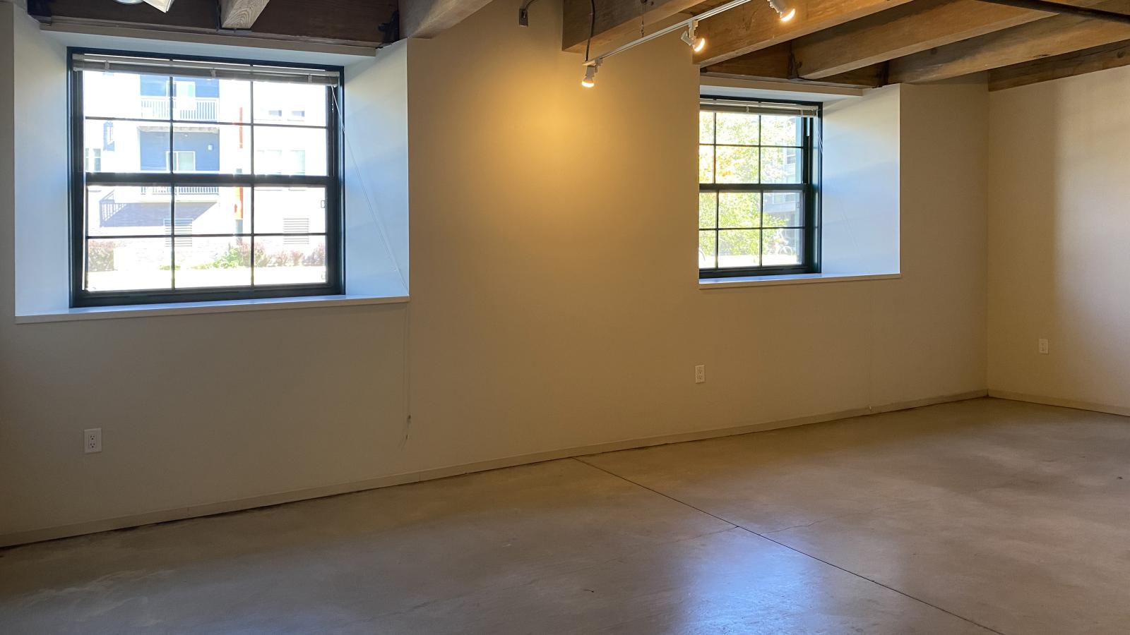 Industrial style one bedroom with polished concrete flooring and open concept design at Tobacco Lofts