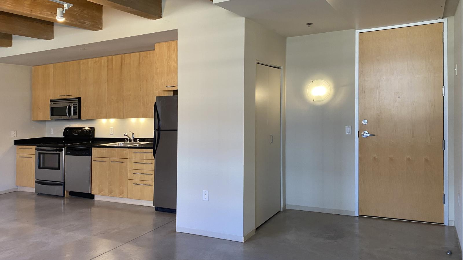 Spacious one bedroom with polished concrete floors, modern appliances, and historic charm at Tobacco Lofts