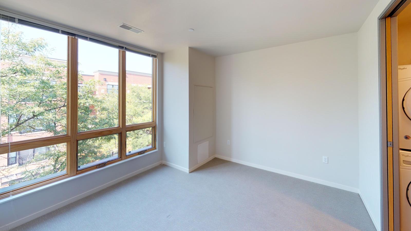 Modern one-bedroom apartment at Quarter Row Apartments in downtown Madison featuring a functional layout, ample storage, and natural light.