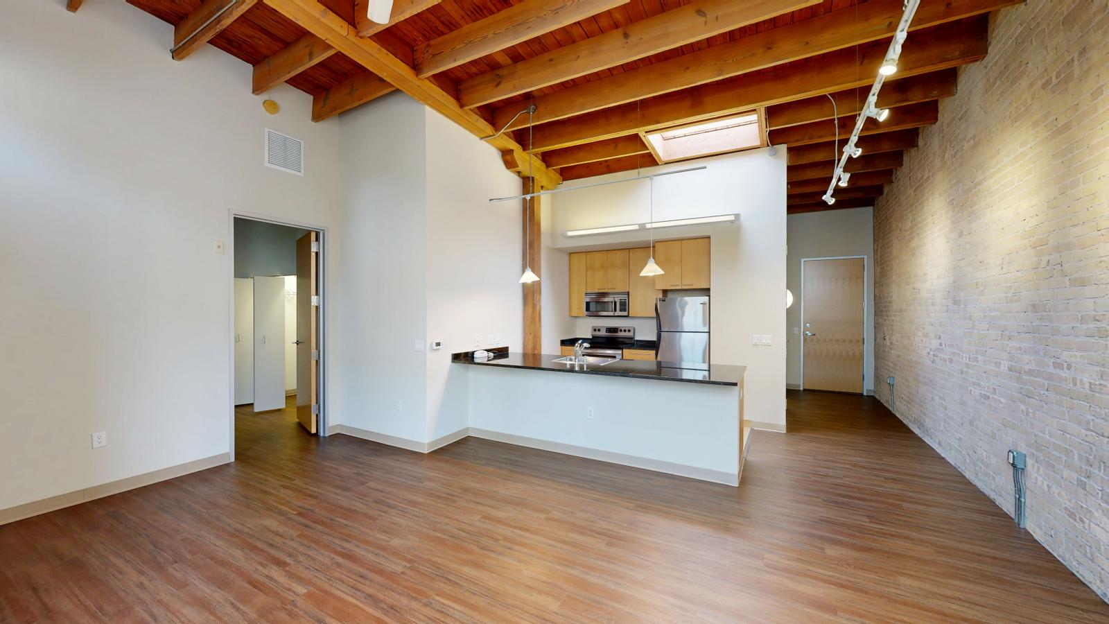 Modern kitchen in a one bedroom apartment with ample counter space and granite countertops at Tobacco Lofts at The Yards in downtown Madison