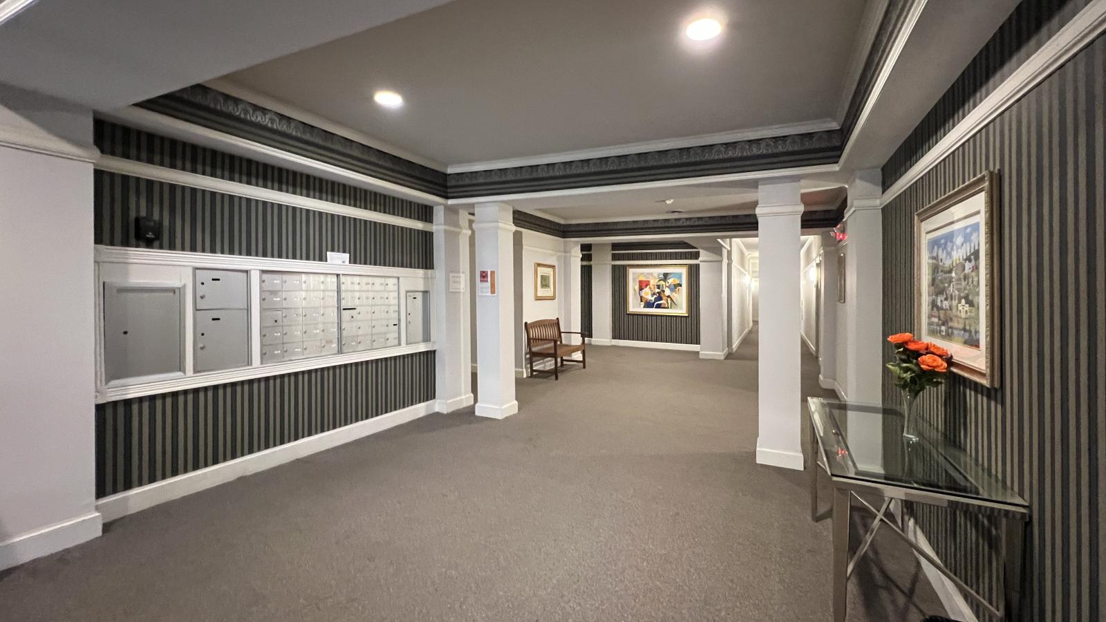 Wilson Bay Apartments lobby with seating, mail area, and package shelving 